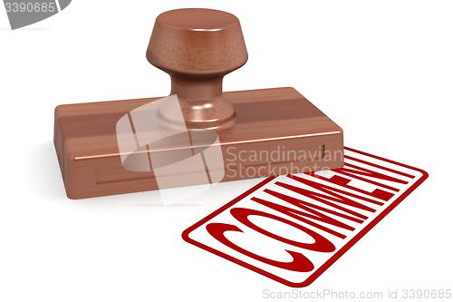 Image of Wooden stamp comment with red text