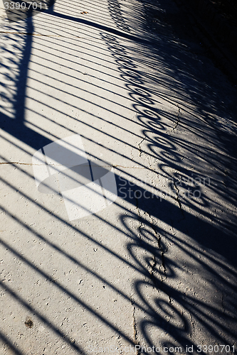 Image of forged fence shadow on an track