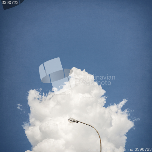 Image of street lamp with cloud and sky