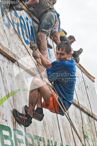 Image of Sportsman storms big wall in extrim race. Tyumen.Russia