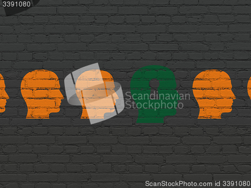 Image of Education concept: head with keyhole icon on wall background