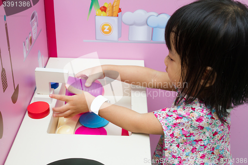 Image of Chinese children role-playing at kitchen