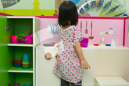 Image of Chinese children role-playing at kitchen