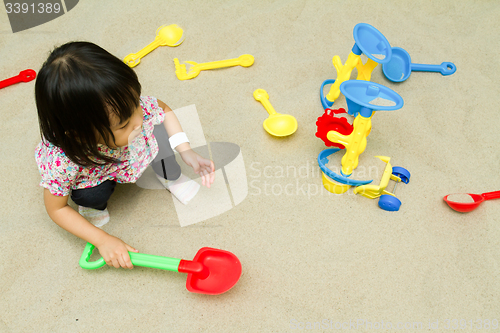 Image of Chinese children playing at indoor sandbox.