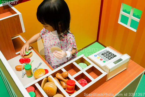 Image of Chinese children role-playing at burger store.