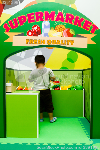Image of Children role-playing at vege store.