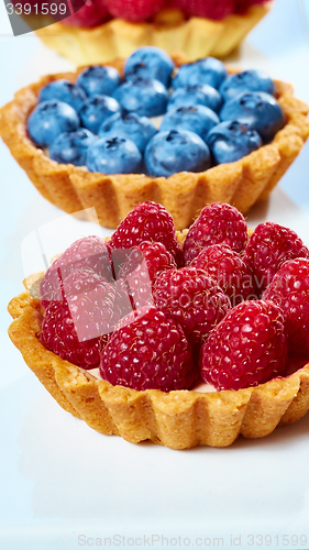 Image of fruit tartlets with raspberries and blueberries 
