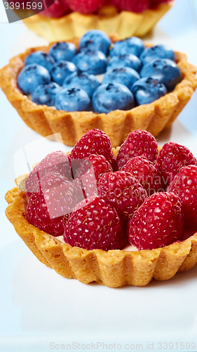 Image of fruit tartlets with raspberries and blueberries 