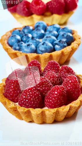 Image of fruit tartlets with raspberries and blueberries 