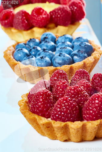 Image of fruit tartlets with raspberries and blueberries 