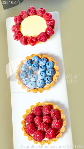 Image of fruit tartlets with raspberries and blueberries 