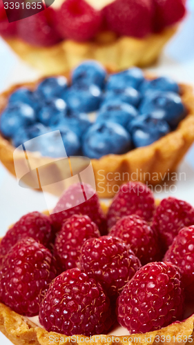 Image of fruit tartlets with raspberries and blueberries 