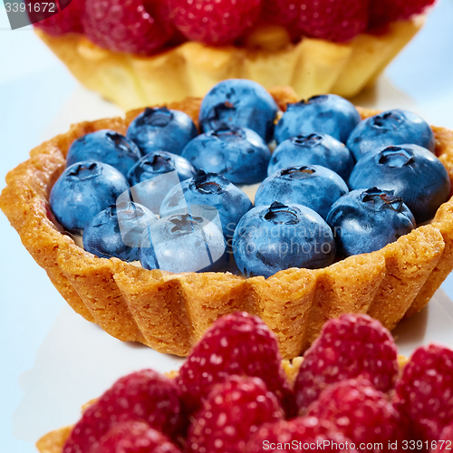 Image of fruit tartlets with raspberries and blueberries 