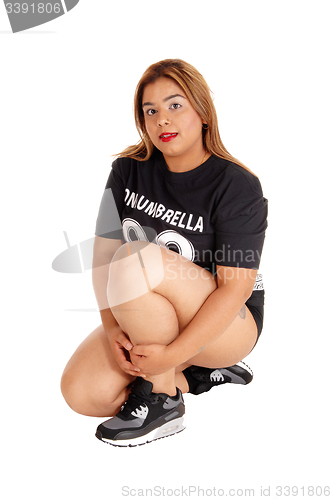 Image of East Indian girl kneeling on floor.