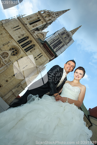 Image of Married couple posing in city