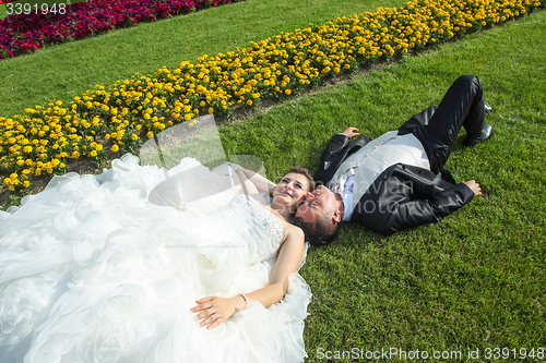 Image of Married couple lying on lawn