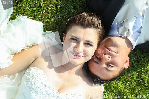 Image of Newlyweds posing on grass