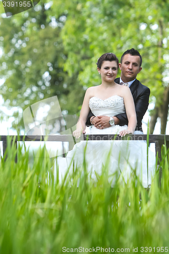 Image of Married couple on wooden bridge