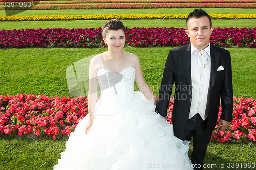 Image of Bride and groom on lawn with flowers