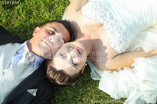 Image of Newlyweds lying on grass