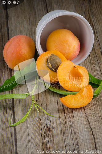 Image of Apricots on wooden table.
