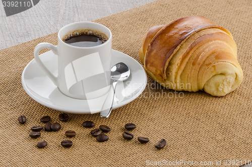 Image of Cup of black coffee and croissant 