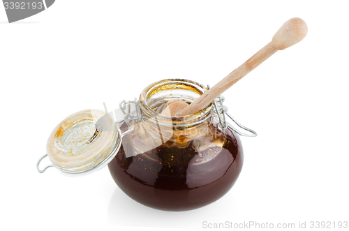 Image of Jar of honey with wooden drizzler