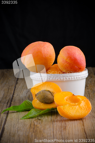 Image of Apricots on wooden table.