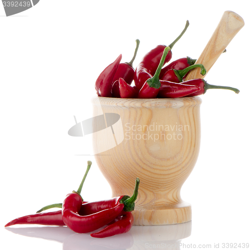 Image of Red chili in wooden mortar 