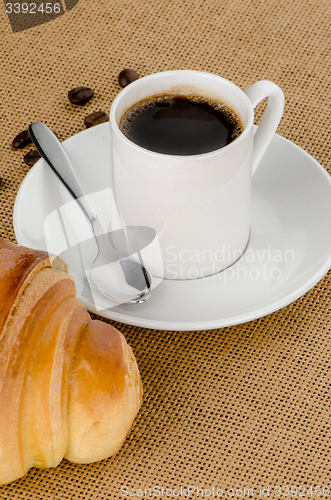 Image of Cup of black coffee and croissant 