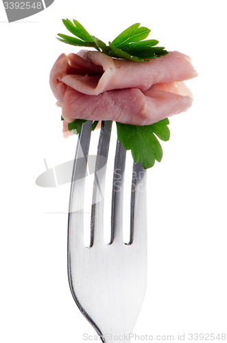 Image of Slice of ham skewered on a fork 