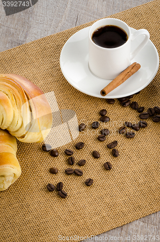 Image of Cup of black coffee and croissant 