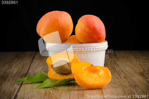 Image of Apricots on wooden table.