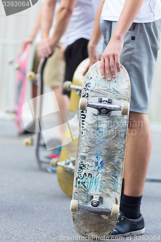 Image of Boys skateboarding on street. Urban life.