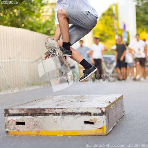 Image of Boys skateboarding on street. Urban life.