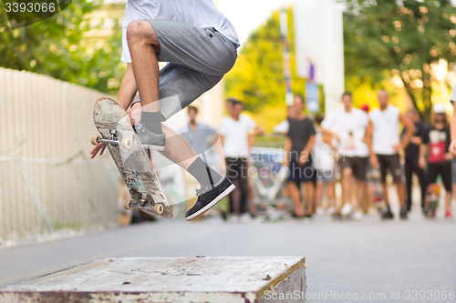 Image of Boys skateboarding on street. Urban life.