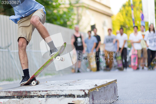 Image of Boys skateboarding on street. Urban life.