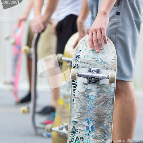 Image of Boys skateboarding on street. Urban life.