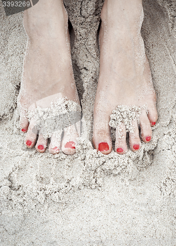 Image of woman feet on the sand