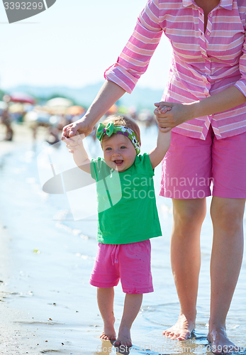 Image of mom and baby on beach  have fun