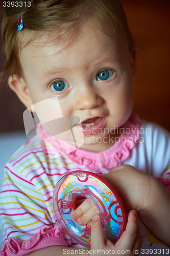 Image of baby playing with toys at home