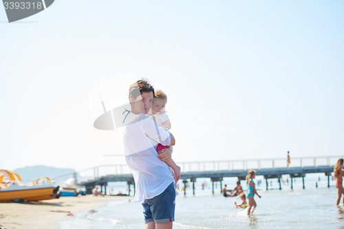 Image of mom and baby on beach  have fun