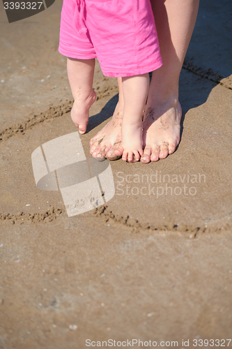 Image of mom and baby on beach  have fun