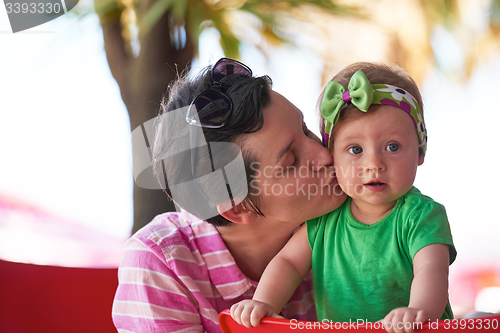Image of portrait of happy young mother and baby