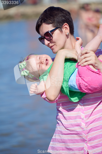 Image of mom and baby on beach  have fun