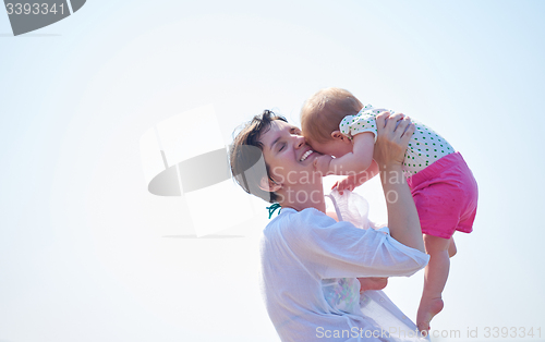 Image of mom and baby on beach  have fun