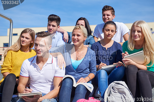 Image of students outside sitting on steps