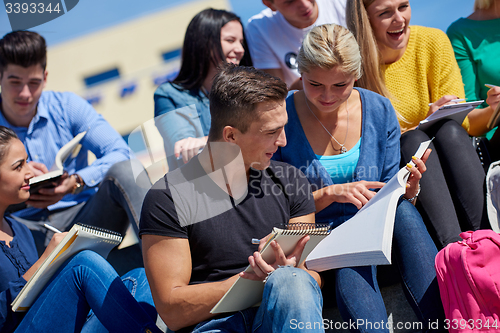 Image of students outside sitting on steps