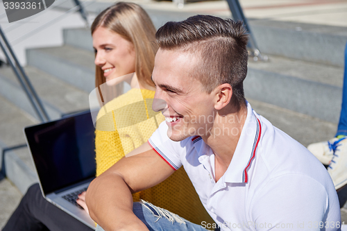 Image of students outside sitting on steps