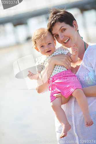 Image of mom and baby on beach  have fun